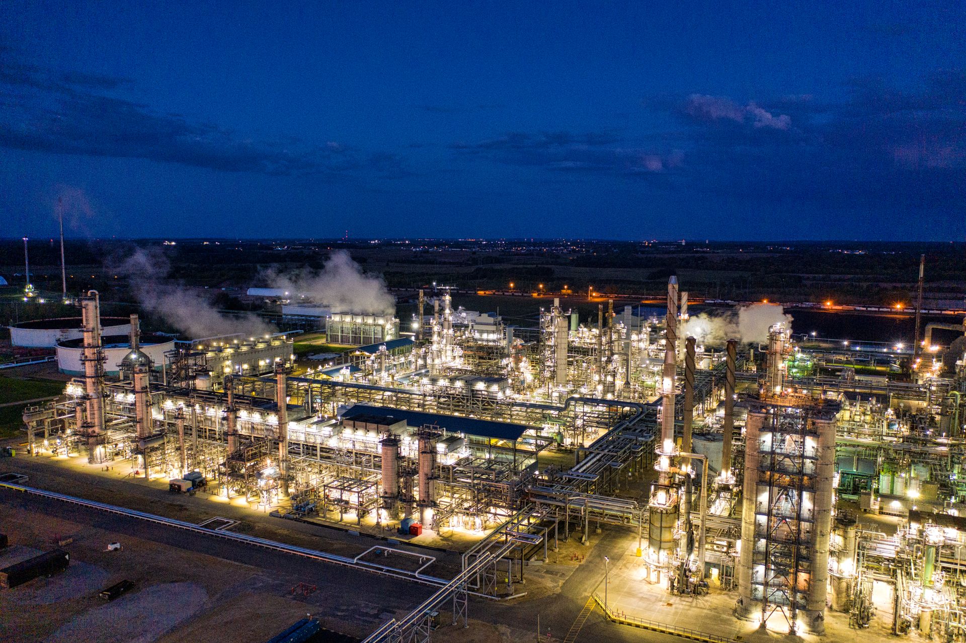 Illuminated biorefinery with storage tanks at night