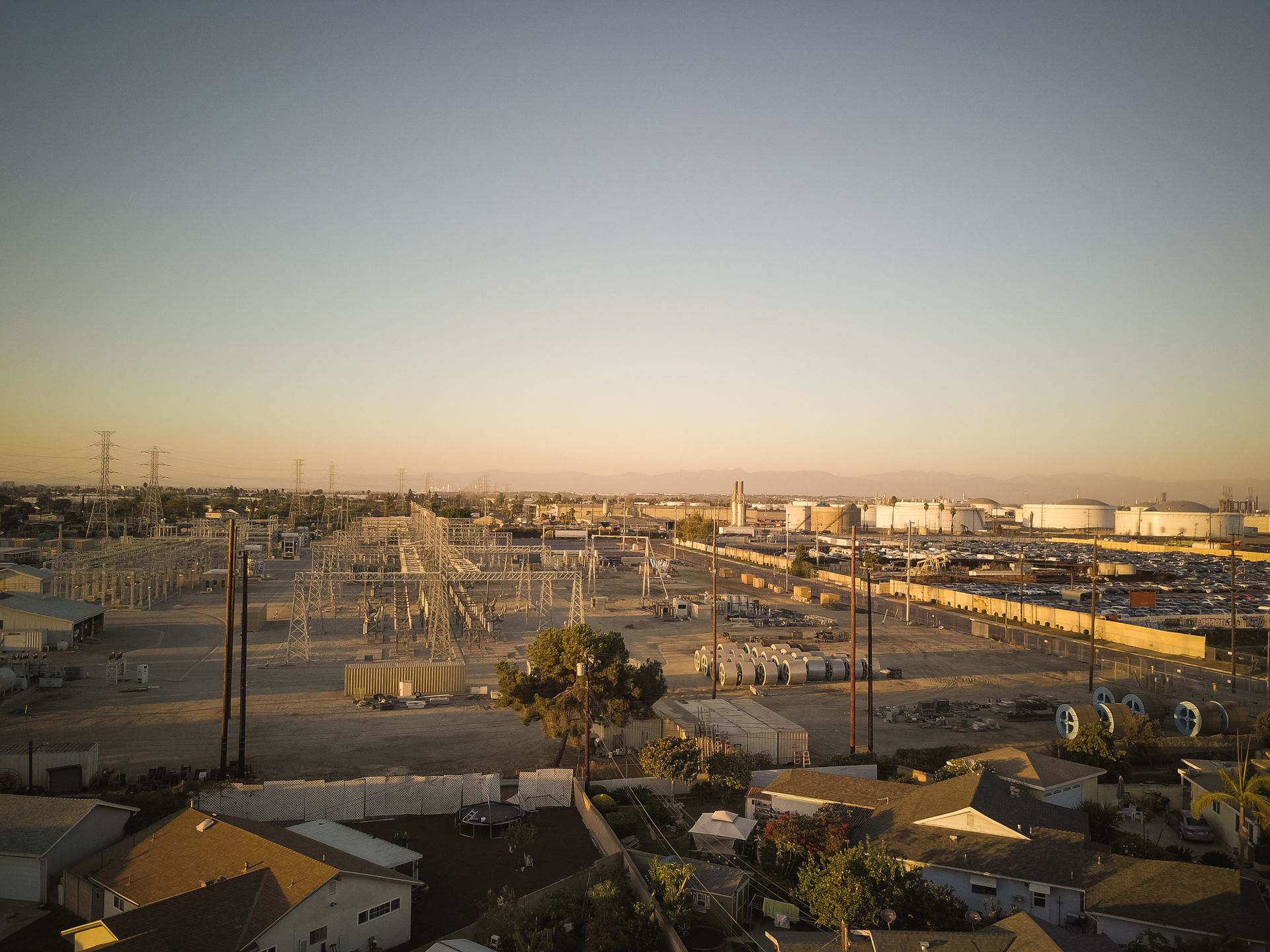 Aerial view of a power plant and substation at sunset